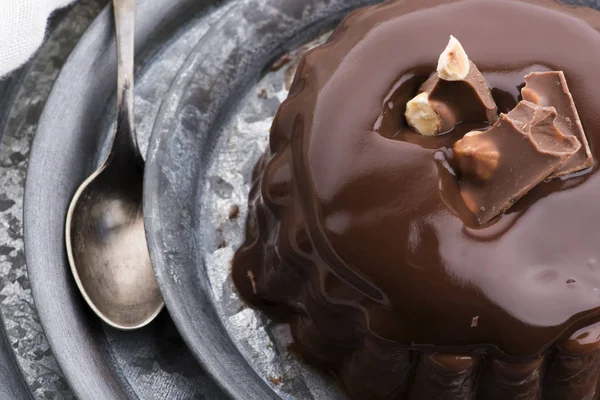 Chocolate pudding with chocolate dressing on a plate