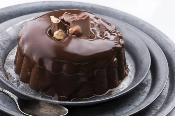 Chocolate pudding with chocolate dressing on a plate