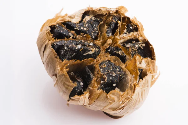 Black garlic cloves isolated on white background — Stock Photo, Image