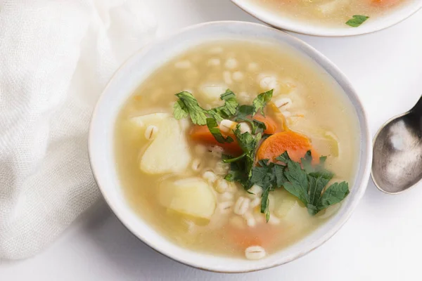 Barley soup, pearl barley in white bowl