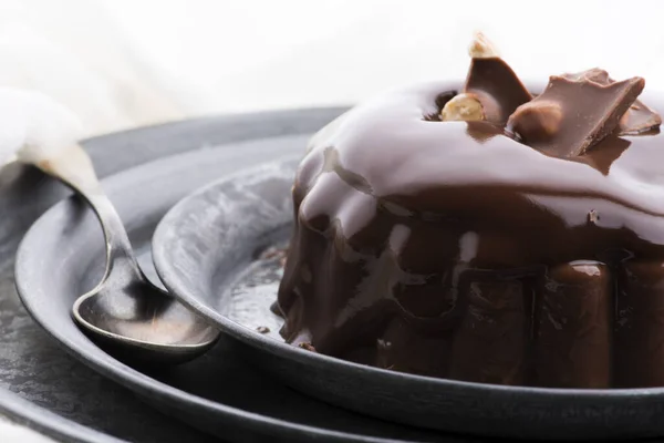 Chocolate pudding with chocolate dressing on a plate