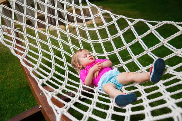 Baby girl swinging in a hammock — Stock Photo, Image