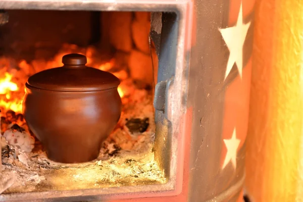 Clay pot in the oven — Stock Photo, Image