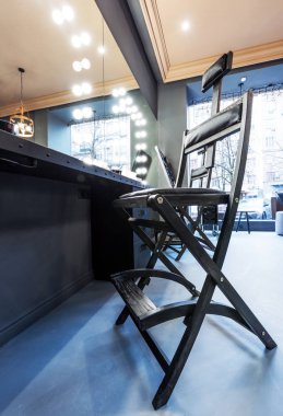 Aynaları, lambaları, koltukları, kozmetik ürünleri olan bir güzellik salonunun modern tasarımcısı.