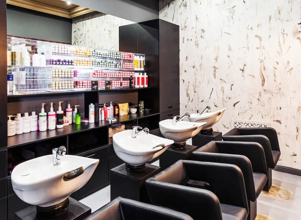 Beauty salon interior - a row of hair washing sinks — Stock Photo, Image