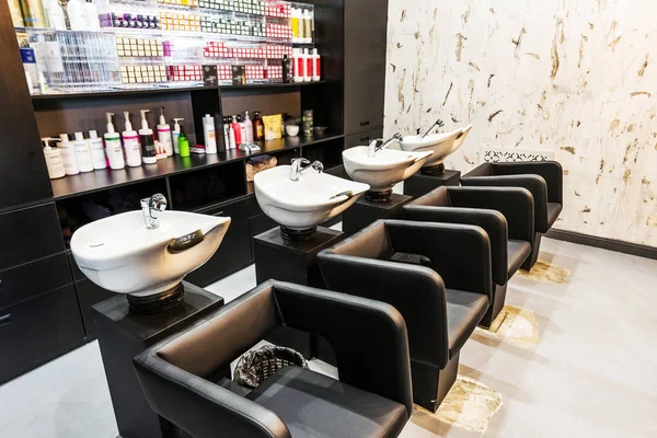 Beauty salon interior - a row of hair washing sinks — Stock Photo, Image
