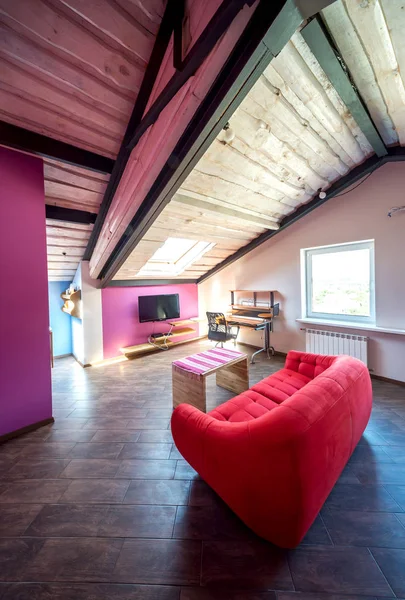 Small living room interior and loft in new home with sloping roof