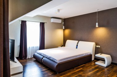 Rahat bir yatağı olan bir otel odası. 