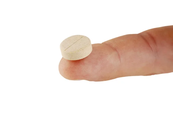 Dose da pílula amarela no dedo humano — Fotografia de Stock