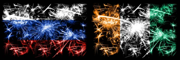 Rússia, Rússia vs Costa do Marfim celebração ano novo fogos de artifício cintilantes bandeiras fundo conceito. Combinação de dois pavilhões dos Estados — Fotografia de Stock