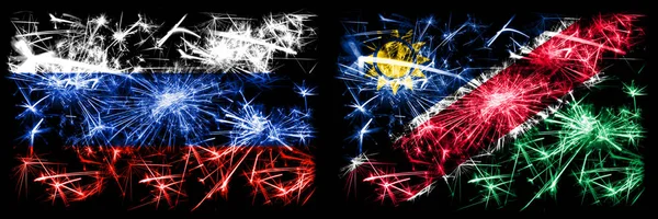 Росія, Росія проти Намібії, Намібія, святкування Нового року, яке блищить феєрверки, відзначає концепт-фон. Комбінація прапорів двох держав. — стокове фото