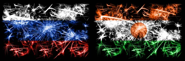 Russia, Russian vs Niger, Nigerian New Year celebration sparkling fireworks flags concept background. Combination of two states flags — Stock Photo, Image