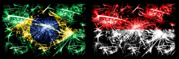 Brazil, Brazilian vs Indonesia, Indonesian New Year celebration sparkling fireworks flags concept background. Combination of two states flags — Stock Photo, Image