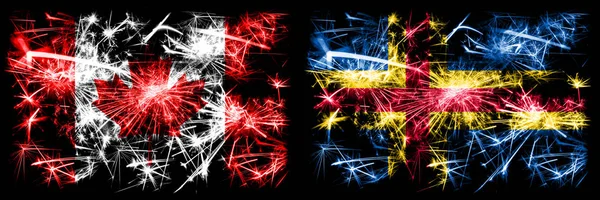 Kanada, kanadische vs aland Neujahrsfeier funkelnden Feuerwerk Flaggen Konzept Hintergrund. Kombination aus zwei abstrakten Staaten Flaggen — Stockfoto