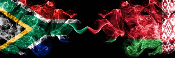 South Africa vs Belarus, Belarusian smoky mystic flags placed side by side. Thick colored silky abstract smoke flags concept — Stock Photo, Image