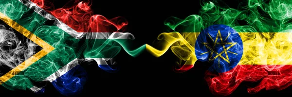 Zuid-Afrika vs Ethiopië, Ethiopische rokerige mystieke vlaggen naast elkaar geplaatst. Dikke gekleurde zijdeachtige abstracte rook vlaggen concept — Stockfoto