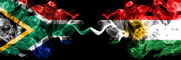 South Africa vs Kurdistan, Kurdish smoky mystic flags placed side by side. Thick colored silky abstract smoke flags concept — Stock Photo, Image