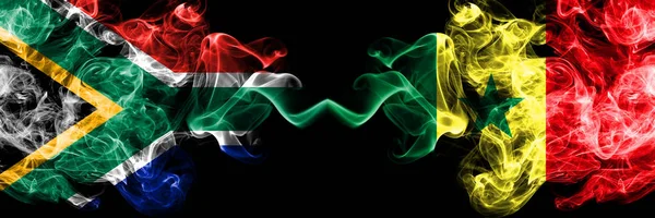 Dél-Afrika vs Szenegál, szenegáli füstös misztikus zászlók egymás mellett. Vastag színű selymes elvont füst zászlók koncepció — Stock Fotó