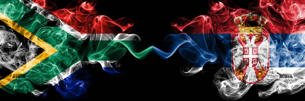 Zuid-Afrika vs Servië, Servische rokerige mystieke vlaggen naast elkaar geplaatst. Dikke gekleurde zijdeachtige abstracte rook vlaggen concept — Stockfoto