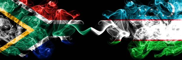 Dél-Afrika vs Üzbegisztán, Üzbegisztán füstös misztikus zászlók egymás mellett. Vastag színű selymes elvont füst zászlók koncepció — Stock Fotó