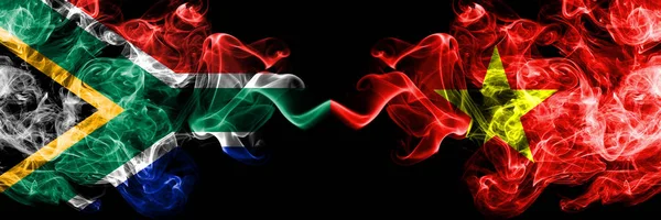 Zuid-Afrika vs Vietnam, Vietnamese rokerige mystieke vlaggen naast elkaar geplaatst. Dikke gekleurde zijdeachtige abstracte rook vlaggen concept — Stockfoto