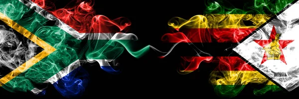 Südafrika vs zimbabwe, zimbabwische rauchige mystische flaggen nebeneinander platziert. dicken farbigen seidigen abstrakten Rauch Flaggen Konzept — Stockfoto