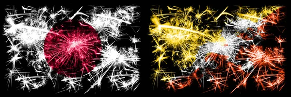 Japan, japan vs bhutan, bhutanesische Neujahrsfeier funkelnden Feuerwerk Flaggen Konzept Hintergrund. Kombination aus zwei abstrakten Staaten Flaggen — Stockfoto