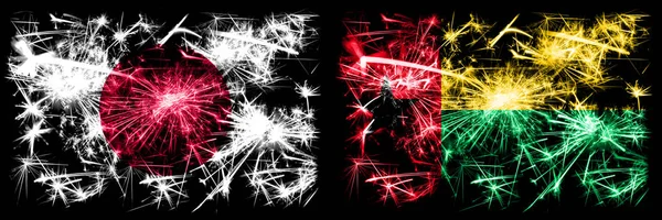 日本、日本与几内亚比绍的新年庆祝活动闪烁着烟花的概念背景. 两种抽象状态标志的组合 — 图库照片