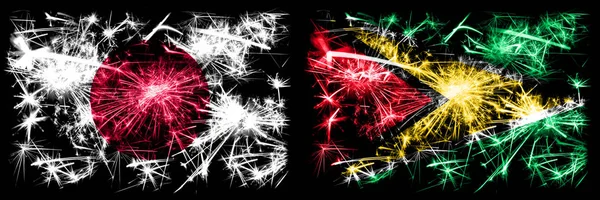 Japão, Japonês vs Guiana, celebração do Ano Novo da Guiana fogos de artifício cintilantes fundo conceito bandeiras. Combinação de duas bandeiras de estados abstratos — Fotografia de Stock