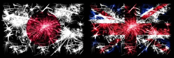 Japão, Japão vs Reino Unido, Grã-Bretanha, celebração do Ano Novo Britânico fogos de artifício espumantes bandeiras fundo conceito. Combinação de duas bandeiras de estados abstratos — Fotografia de Stock