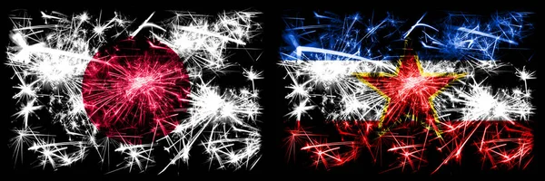Japan, Japanese vs Yugoslavia, Yugoslavian New Year celebration sparkling fireworks flags concept background. Combination of two abstract states flags