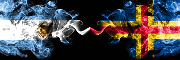 Argentina vs Aland smoky mystic fire flags placed side by side. Thick colored silky abstract smoke flags concept — Stock Photo, Image