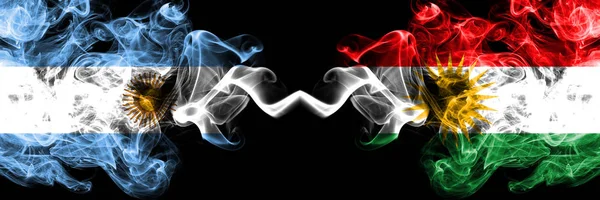 Argentina vs Kurdistan, Kurdish smoky mystic fire flags placed side by side. Thick colored silky abstract smoke flags concept — Stock Photo, Image