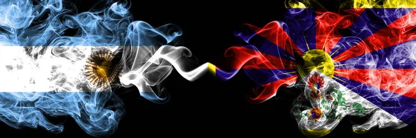 Argentina vs Tibet, Tibetan smoky mystic fire flags placed side by side. Thick colored silky abstract smoke flags concept — Stock Photo, Image