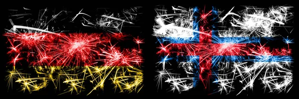 Deutschland, Deutschland vs Färöer Inseln Silvesterfeier Reise funkelnden Feuerwerk Flaggen Konzept Hintergrund. Kombination aus zwei abstrakten Staaten Flaggen. — Stockfoto