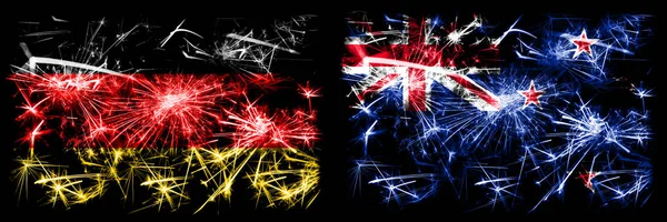 Alemanha, Alemanha vs Nova Zelândia, Nova Zelândia celebração do Ano Novo viagem fogos de artifício cintilantes fundo conceito bandeiras. Combinação de duas bandeiras de estados abstratos . — Fotografia de Stock