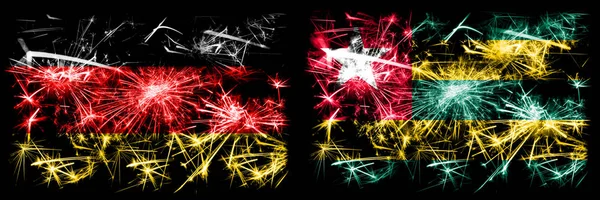 Deutschland, deutsch vs togo, togolesische Neujahrsfeier reisen funkelnde Feuerwerk Flaggen Konzept Hintergrund. Kombination aus zwei abstrakten Staaten Flaggen. — Stockfoto