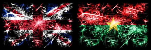 Great Britain, United Kingdom vs Burkina Faso New Year celebration travel sparkling fireworks flags concept background. Combination of two abstract states flags. — Stock Photo, Image