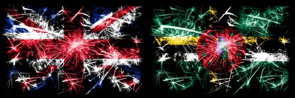 Great Britain, United Kingdom vs Dominica New Year celebration travel sparkling fireworks flags concept background. Combination of two abstract states flags. — Stock Photo, Image