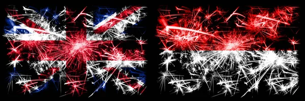 Grã-Bretanha, Reino Unido vs Indonésia, celebração do Ano Novo indonésio viajar fogos de artifício espumantes bandeiras fundo conceito. Combinação de duas bandeiras de estados abstratos . — Fotografia de Stock