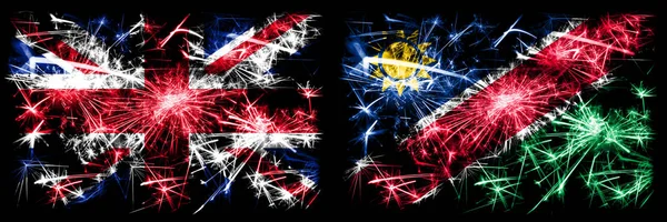 Grã-Bretanha, Reino Unido vs Namíbia, Namíbia celebração do Ano Novo viagem fogos de artifício cintilantes fundo conceito bandeiras. Combinação de duas bandeiras de estados abstratos . — Fotografia de Stock