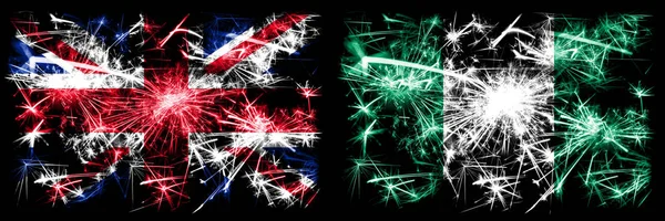 Gran Bretagna, Regno Unito vs Nigeria, celebrazione del Capodanno nigeriano viaggiare scintillanti fuochi d'artificio bandiere concetto di sfondo. Combinazione di due bandiere di stati astratti . — Foto Stock