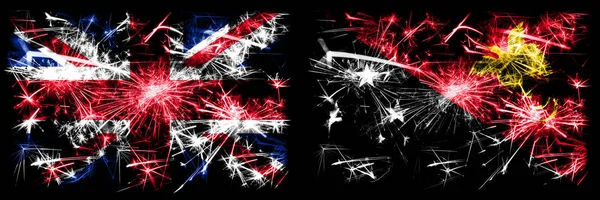 Großbritannien, Vereinigtes Königreich vs Papua Neuguinea Neujahrsfeier Reise funkelnden Feuerwerk Flaggen Konzept Hintergrund. Kombination aus zwei abstrakten Staaten Flaggen. — Stockfoto