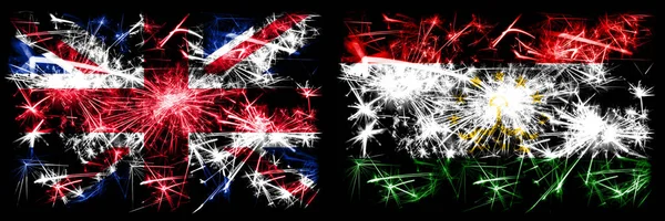 Great Britain, United Kingdom vs Tajikistan, Tajikistani New Year celebration travel sparkling fireworks flags concept background. Combination of two abstract states flags. — Stock Photo, Image