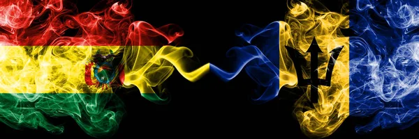 Bolivia, Bolivian vs Barbados, Barbadian smoky mystic states flags placed side by side. Concept and idea thick colored silky abstract smoke flags — Stock Photo, Image