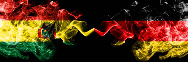 Bolivia, Bolivian vs Germany, German smoky mystic states flags placed side by side. Concept and idea thick colored silky abstract smoke flags