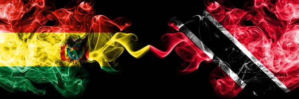 Bolívia, Bolívia vs Trinidad és Tobago füstös misztikus államok zászlók egymás mellett. Koncepció és ötlet vastag színű selymes elvont füst zászlók — Stock Fotó