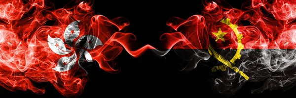 Hong Kong, China vs Angola, Angolan smoky mystic states flags placed side by side. Concept and idea thick colored silky abstract smoke flags