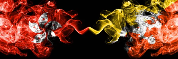 Hong Kong, China vs Bután, Banderas de los estados místicos ahumados butaneses colocadas una al lado de la otra. Banderas de humo abstractas sedosas de color grueso concepto e idea — Foto de Stock