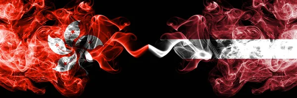 Hong Kong, China vs Latvia, Latvian smoky mystic states flags placed side by side. Concept and idea thick colored silky abstract smoke flags — Stock Photo, Image
